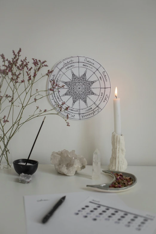 a white table topped with a metal tray and candle