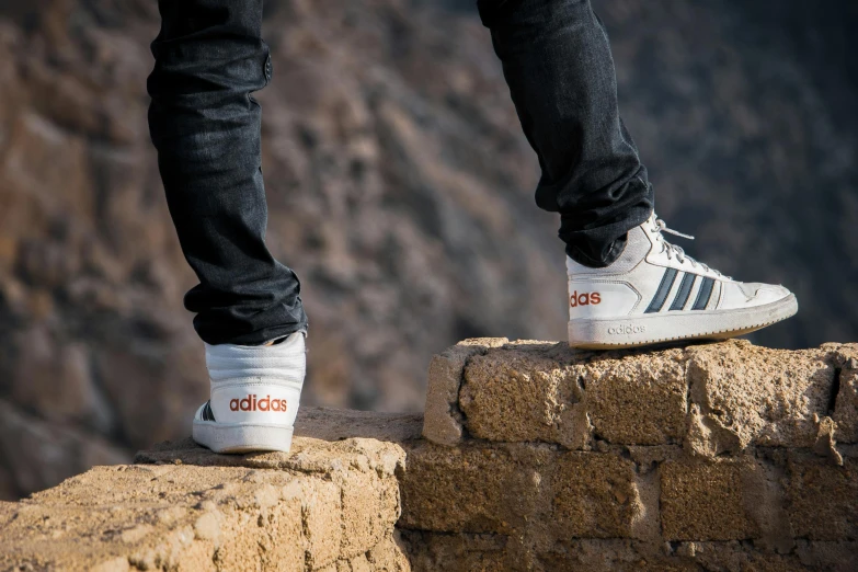 man's feet on top of wall outdoors