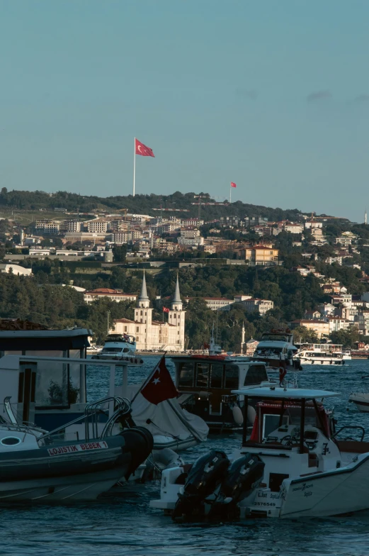 several small boats in a harbor near some buildings