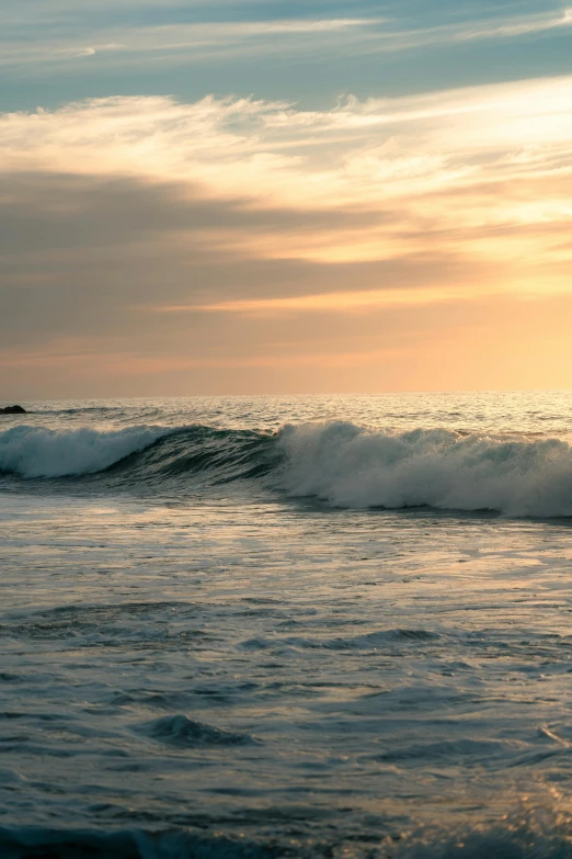 a lone wave breaks into the water in this po