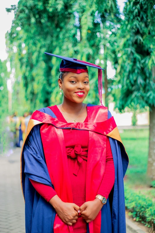 a smiling young woman dressed in graduation clothes