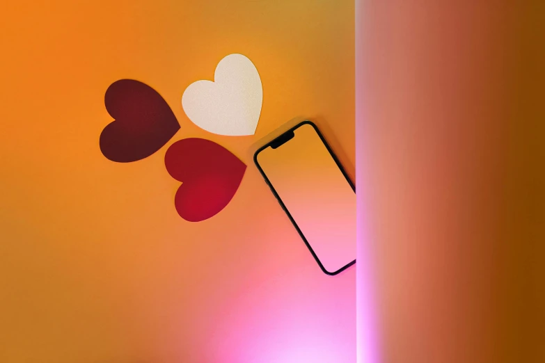 an iphone with heart shapes and a light that is lit