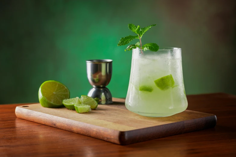 a green drink with lime on the side