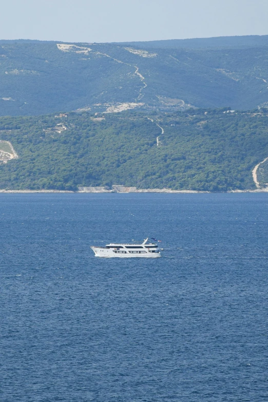 a small boat is in the middle of the open ocean