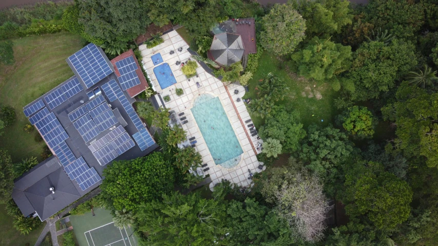 an aerial view of a large house with pool