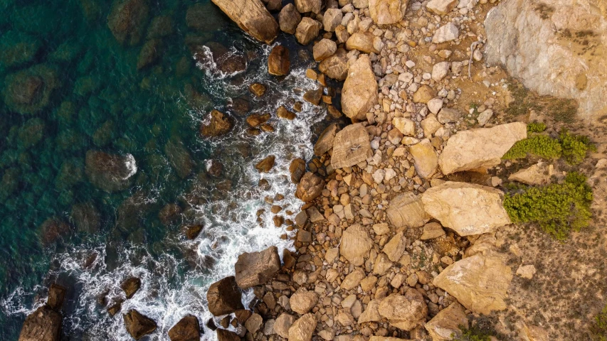 a rocky coast next to a body of water