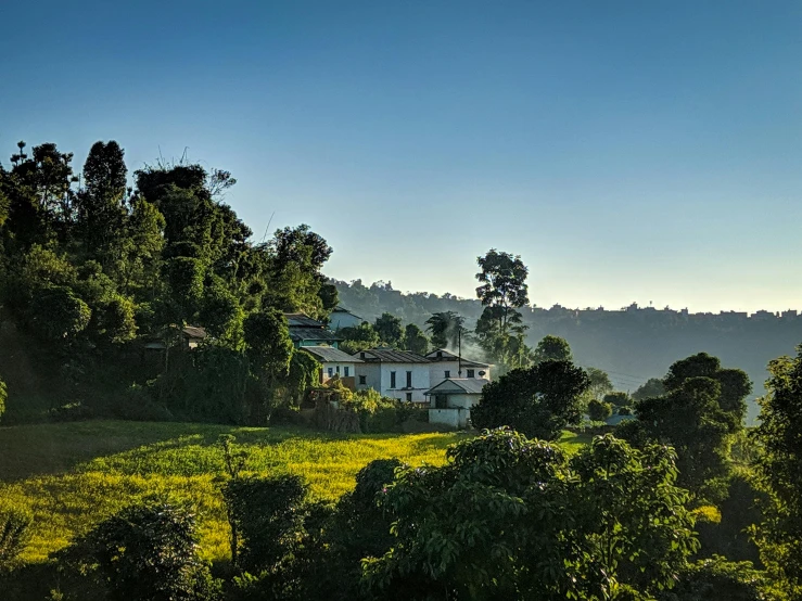 a white house is nestled on a hill