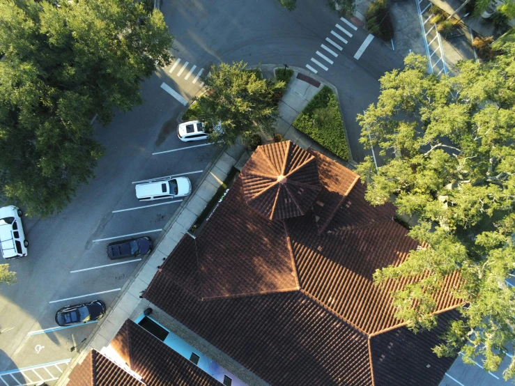 an aerial view of two buildings that have brown tiles on the roof