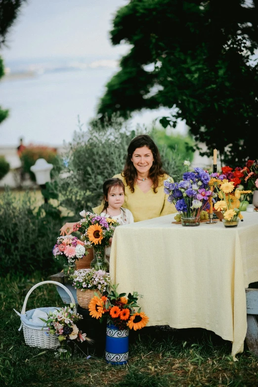 an adorable little girl sitting next to her mother