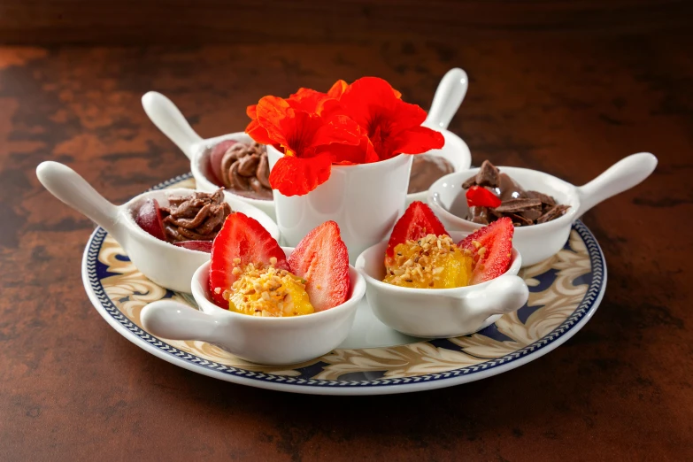 three desserts are arranged in small bowls on a plate