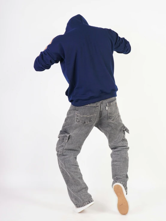 a man is skateboarding in a studio and posing