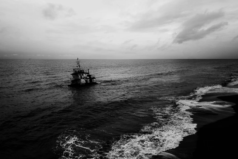 black and white po of a ship in the ocean