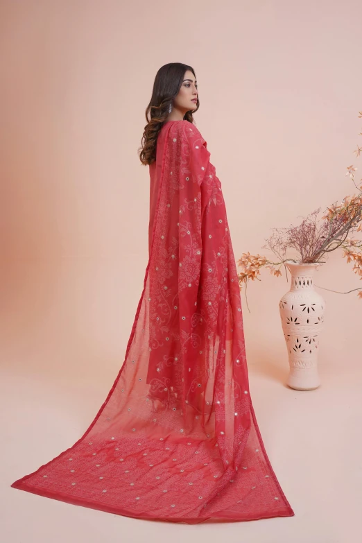 a woman wearing a red and silver lace shawl