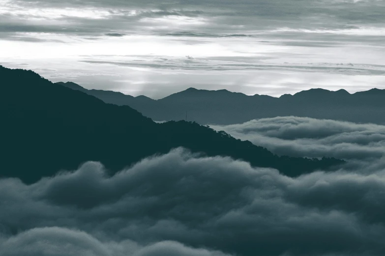 the sky above a bunch of mountain tops is blue