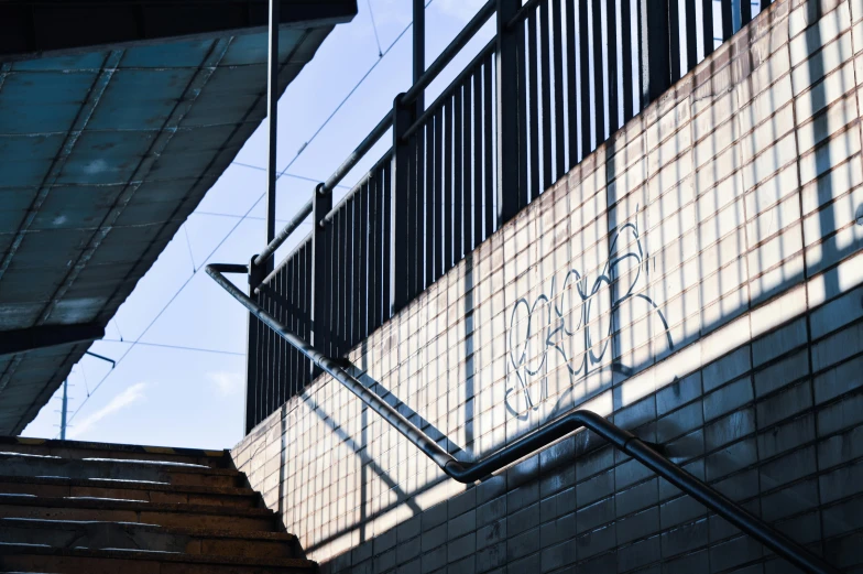 an escalator with graffiti on it next to some stairs