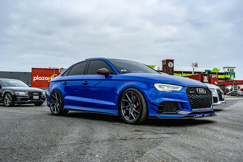 an all - black audi rs3 is in the parking lot