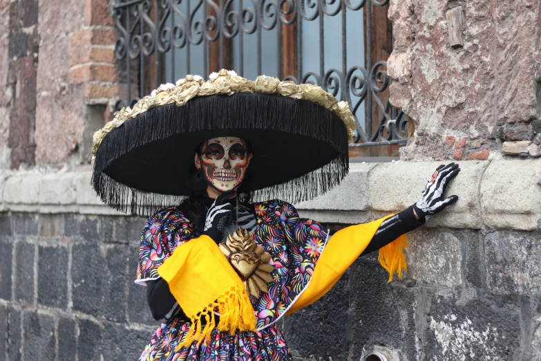 a mexican woman with an elaborate hat and costume