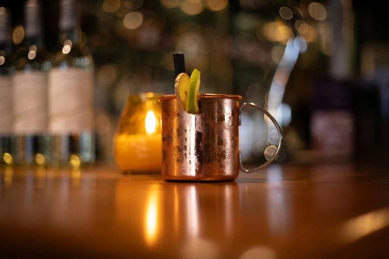 two copper mugs filled with champagne and orange peels