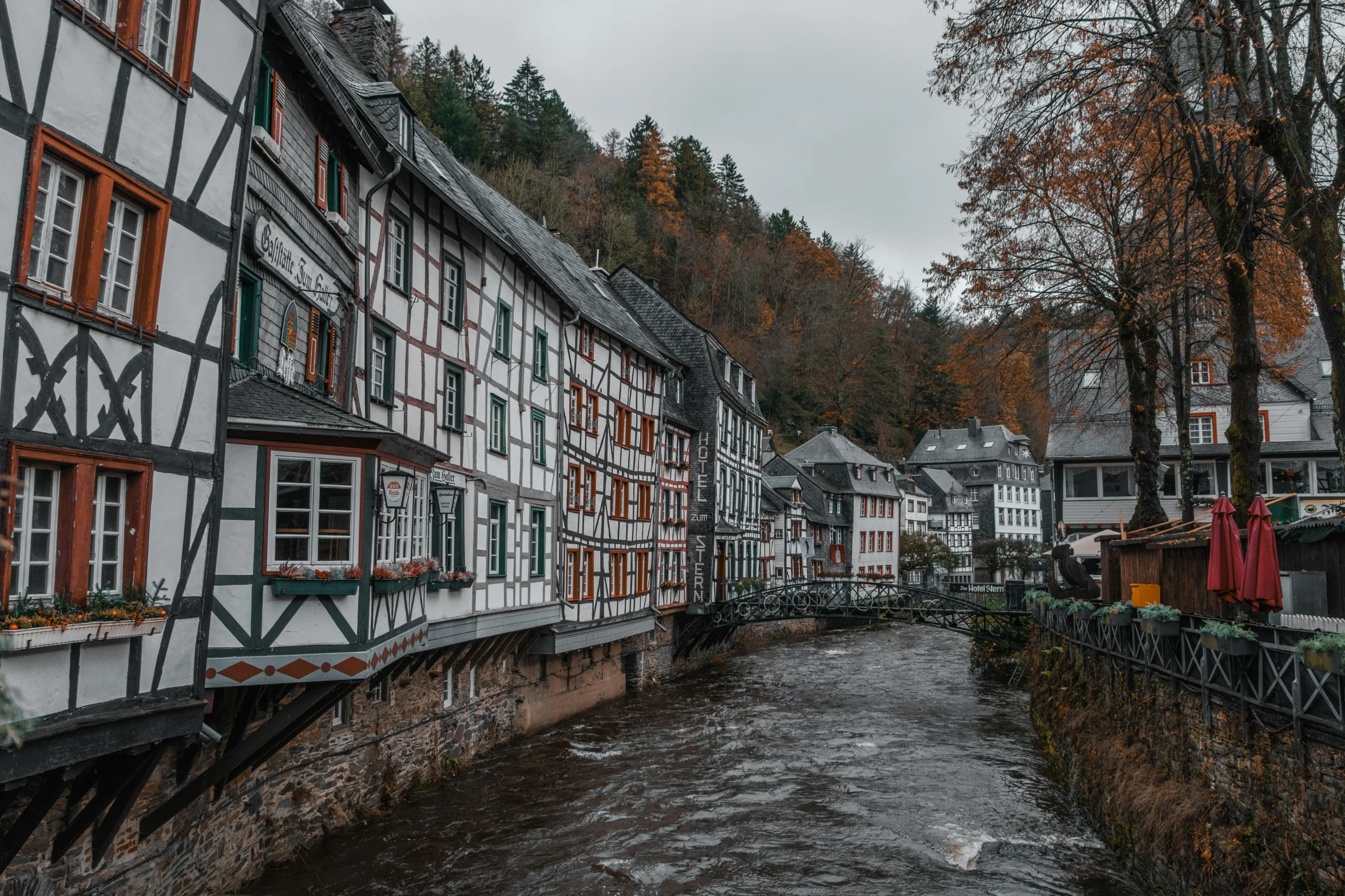 colorful houses are near the water and trees