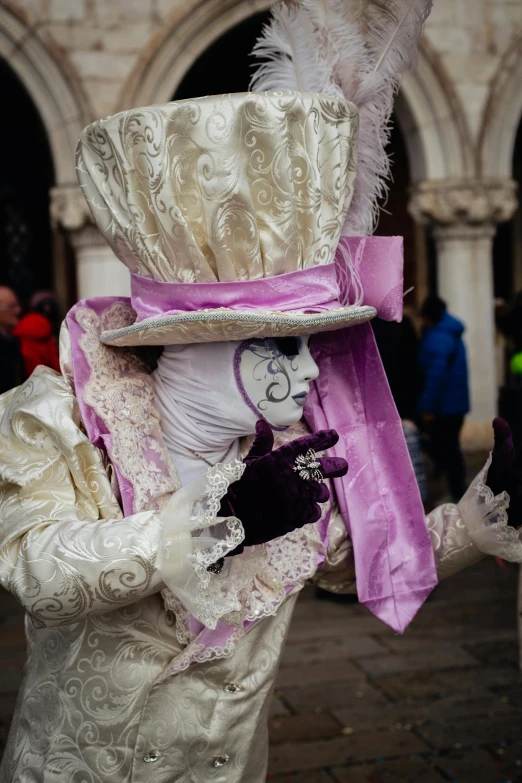 an elaborately decorated woman with an odd hat, feather, and headpiece