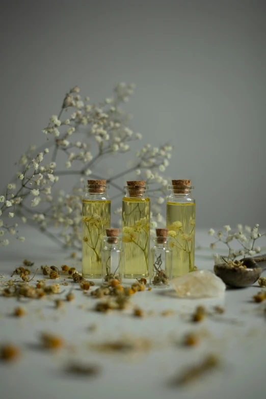 three bottles with flowers in them sitting next to each other