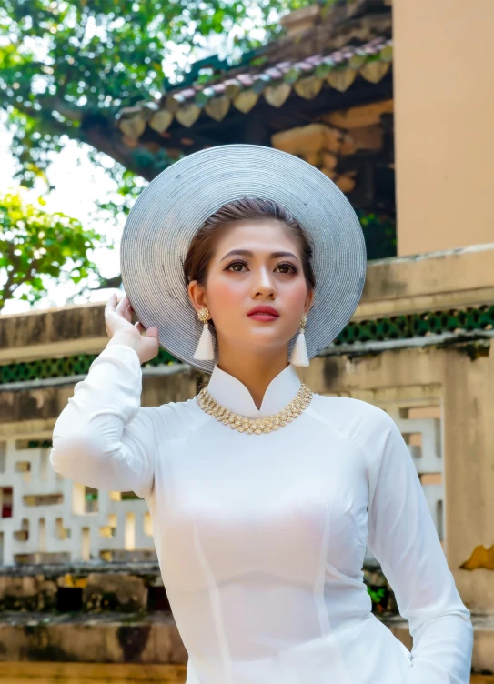 woman with large hat in white outfit and dress