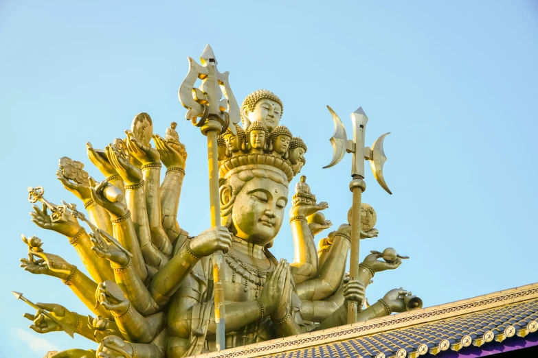 large statue with many decorations in front of blue sky