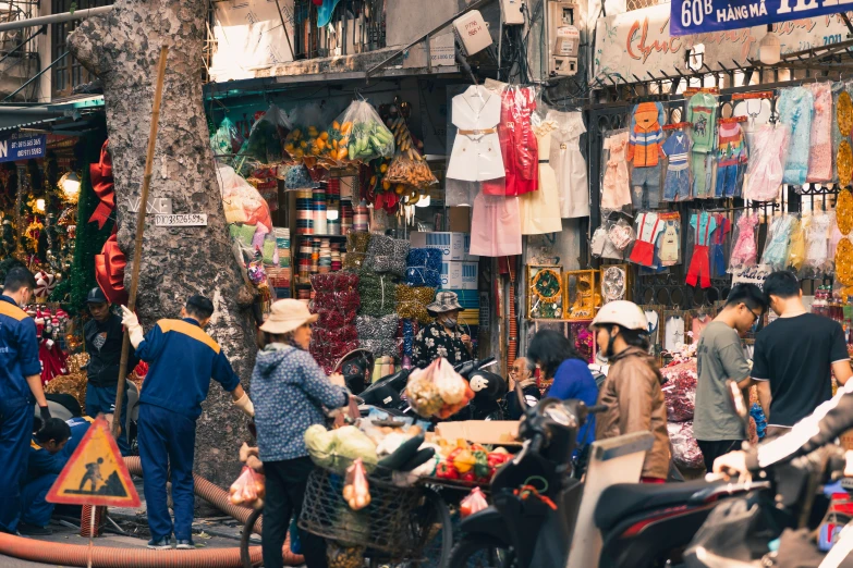 a group of people standing around a shop