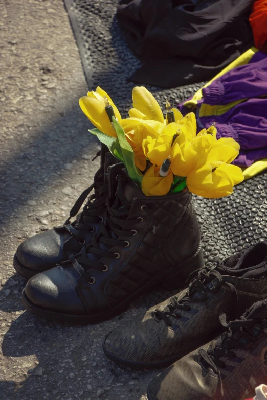 an open pair of boot with flowers in them