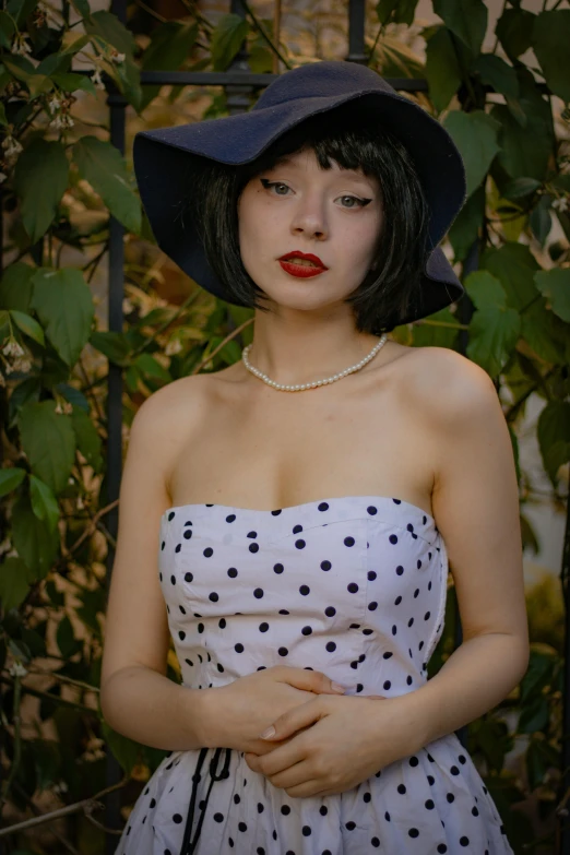 a young woman dressed in a polka dot dress