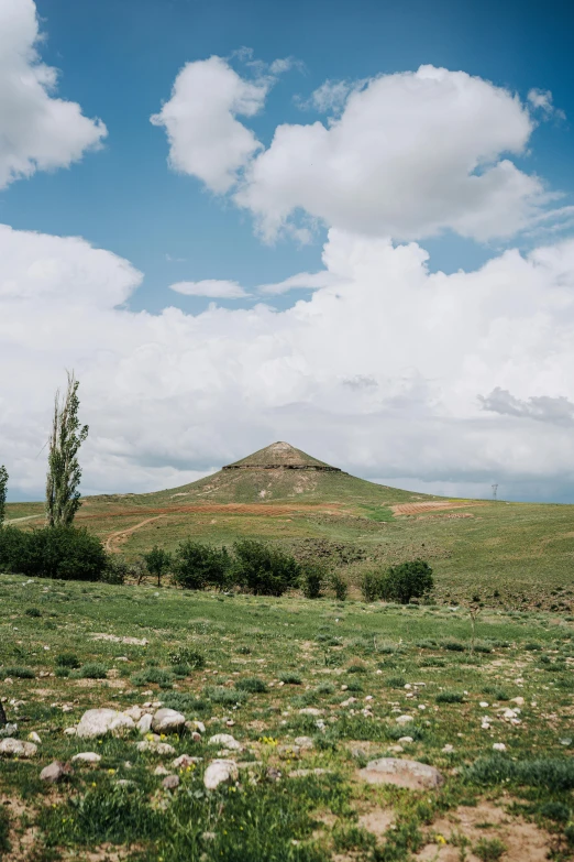 a very pretty grassy hill with a lot of rocks