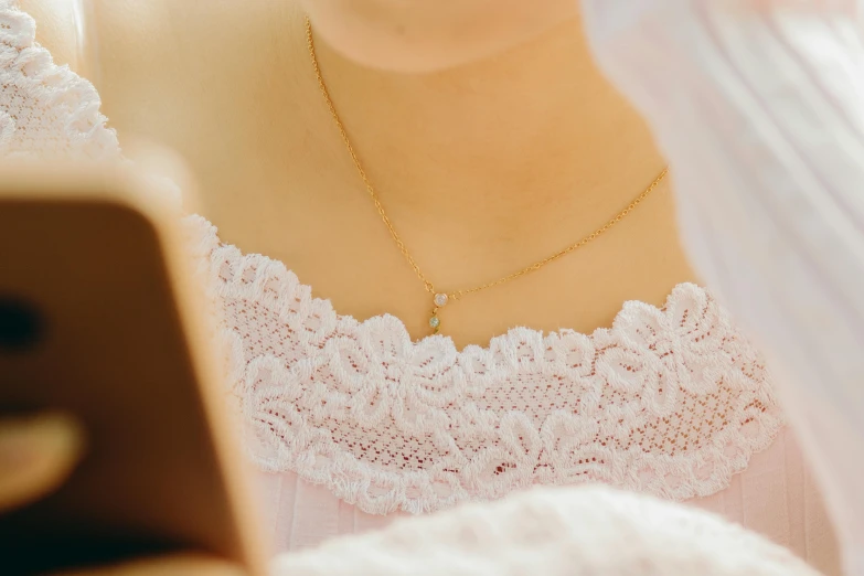 a closeup view of a woman wearing a necklace