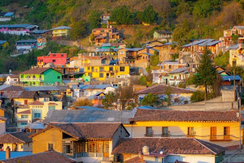 a small town with a colorful mountain range in the background