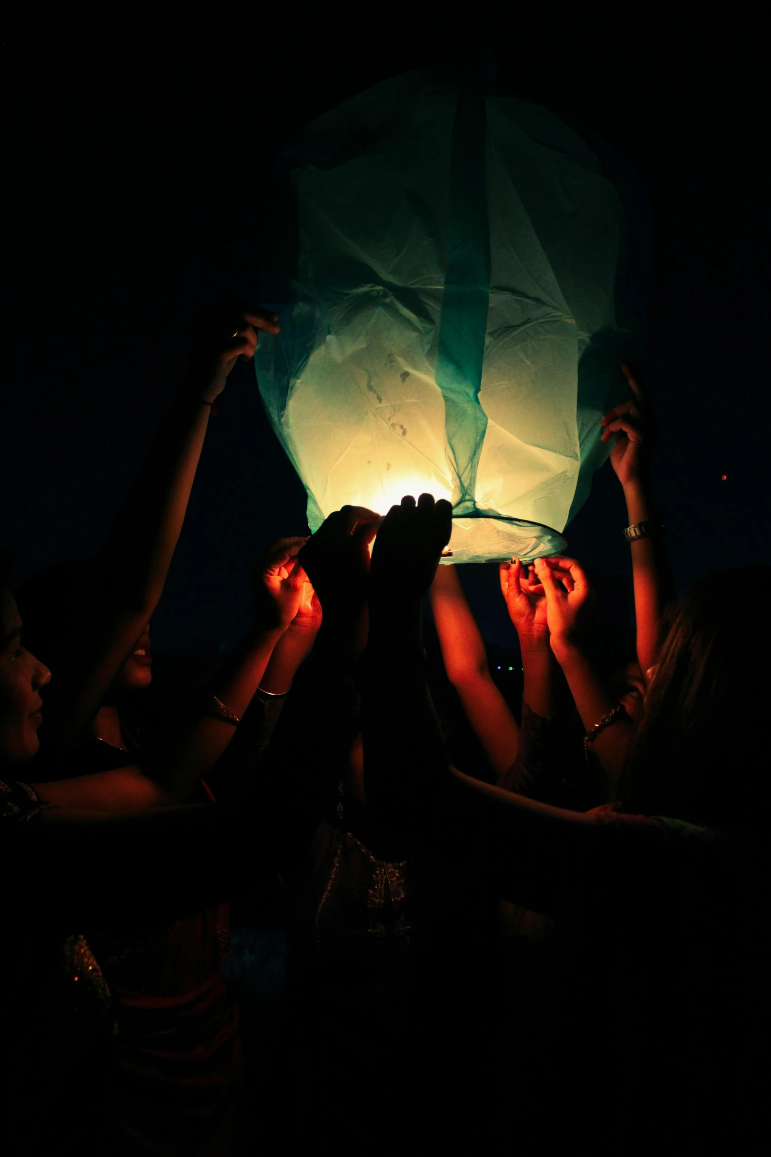 a group of people holding lights in the air