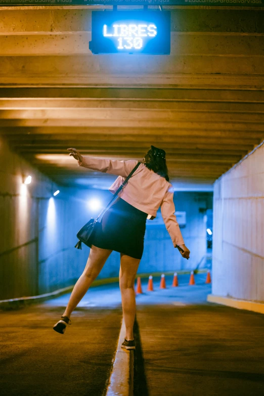 a girl is riding a skateboard inside a tunnel