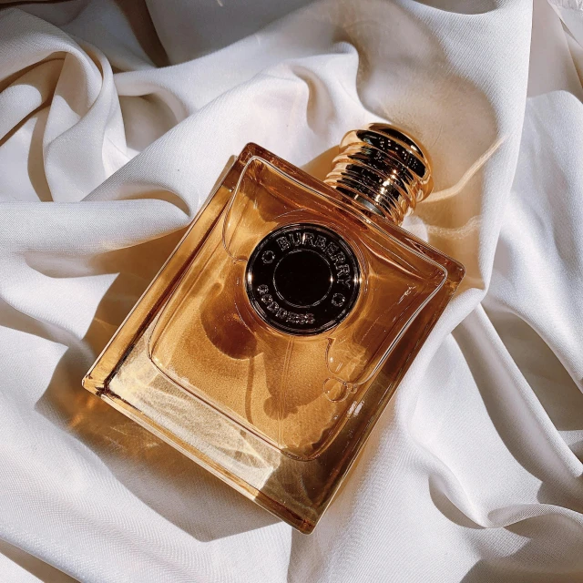 an image of a bottle of perfume on fabric