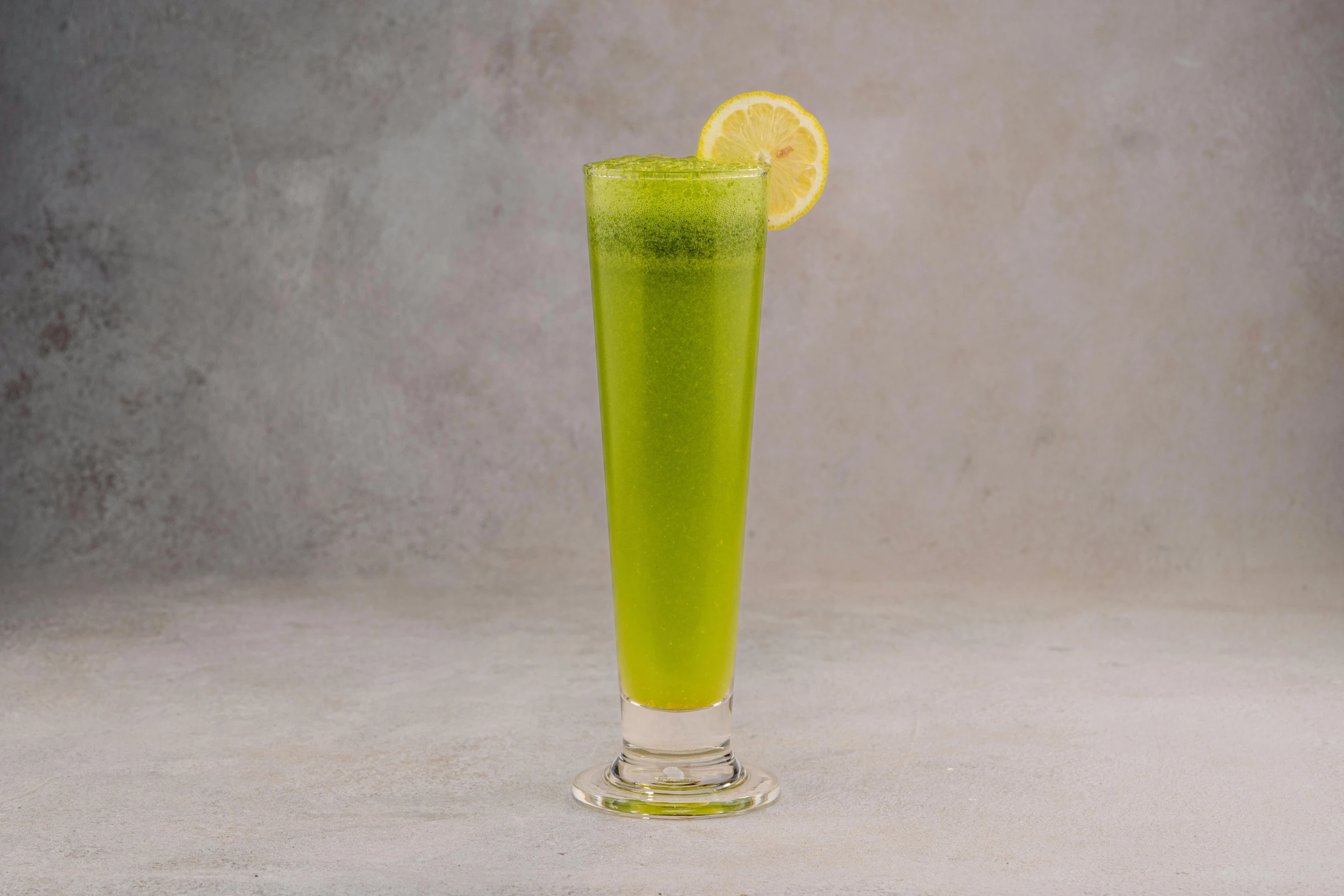 a green drink with lime in the middle