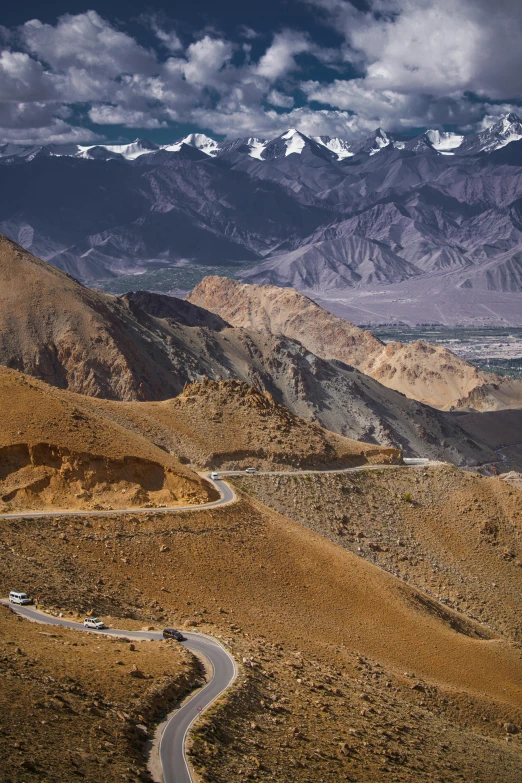 a truck is driving down a road on a hill