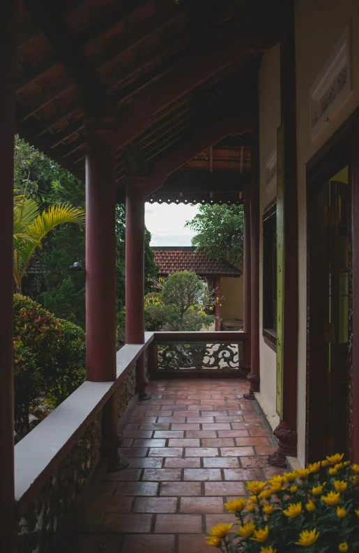 a brick walkway with pillars between the buildings