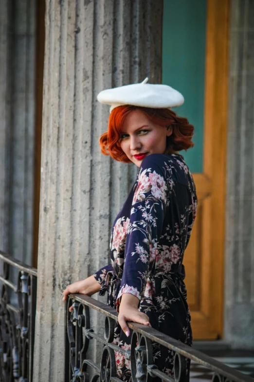 a woman wearing a hat with flowers and a floral pattern