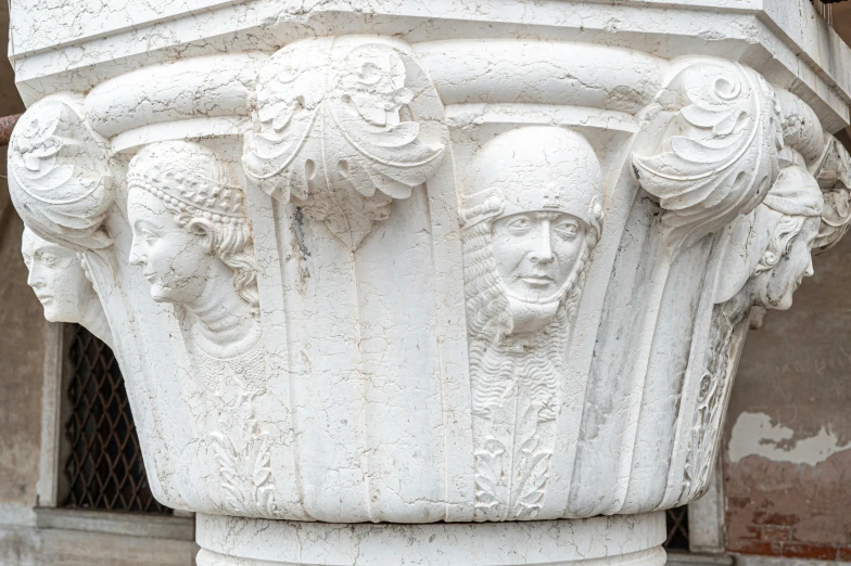 an ornate sculpture depicting three women with heads in a crown and other head