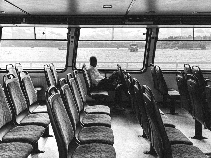 some seats and a lady in a white top are near one another