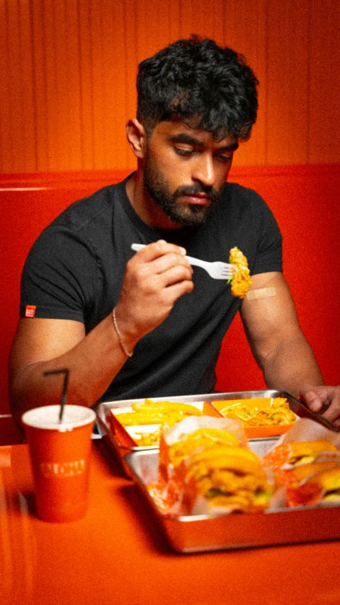 man with a plate of food at a table