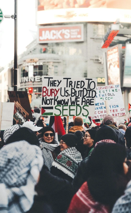 a group of people march with protest signs