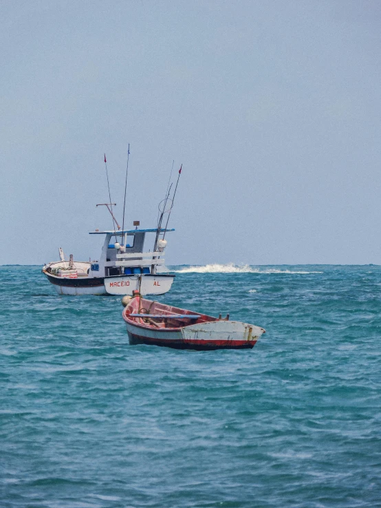 four boats are floating in the blue water