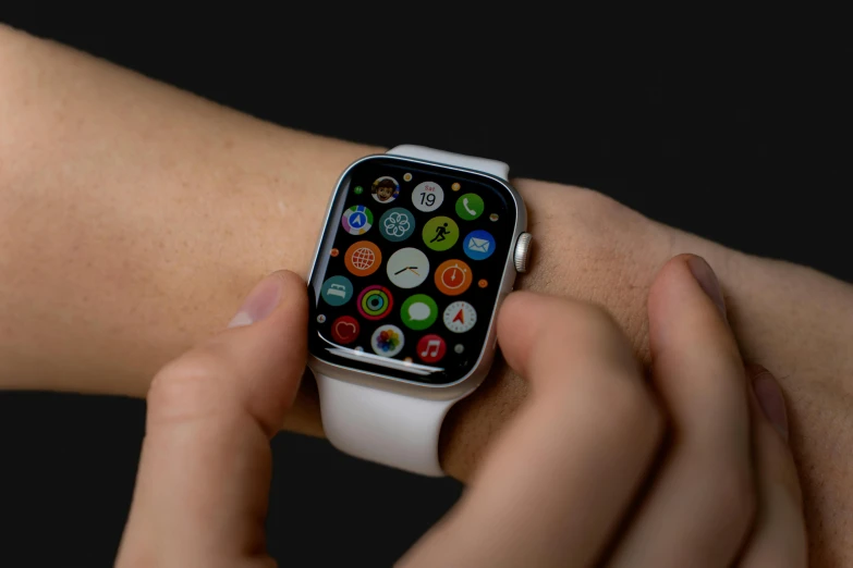 a hand holding an apple watch with many different ons