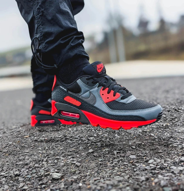 the nike air max on feet with a black and red sole