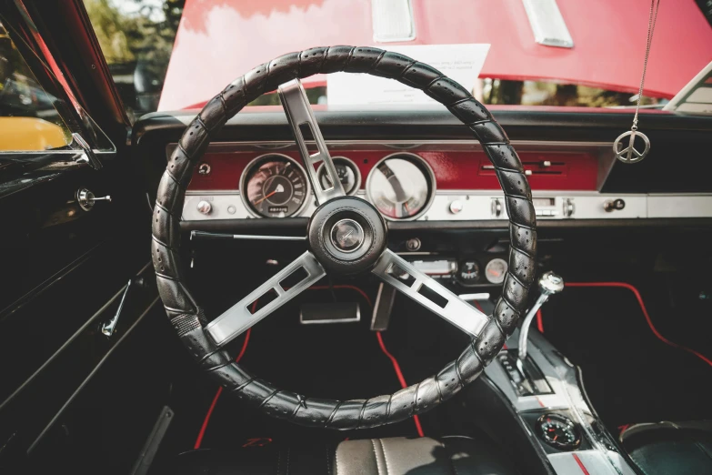 an old, dirty and worn car steering wheel and dashboard
