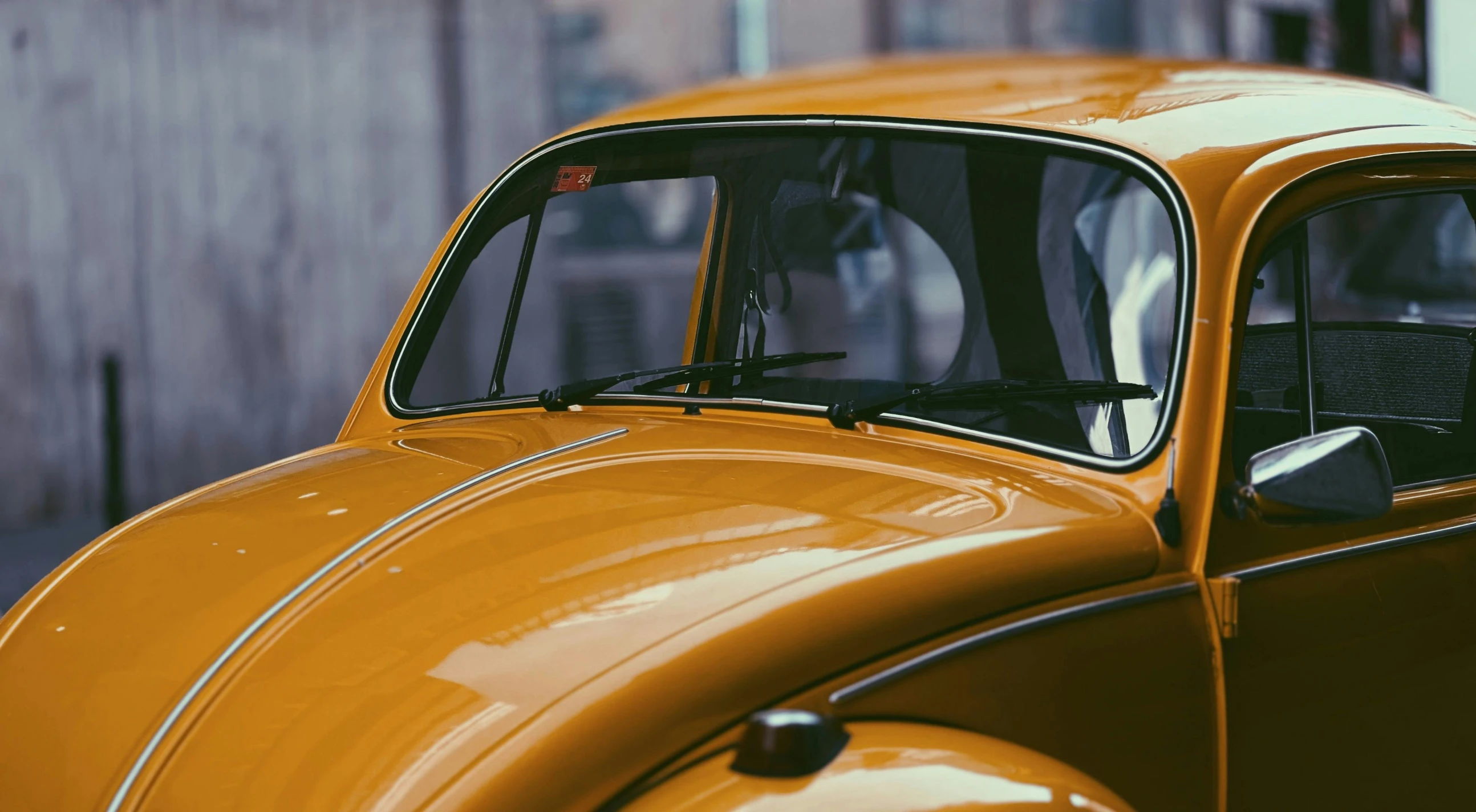 a yellow beetle parked outside of a building