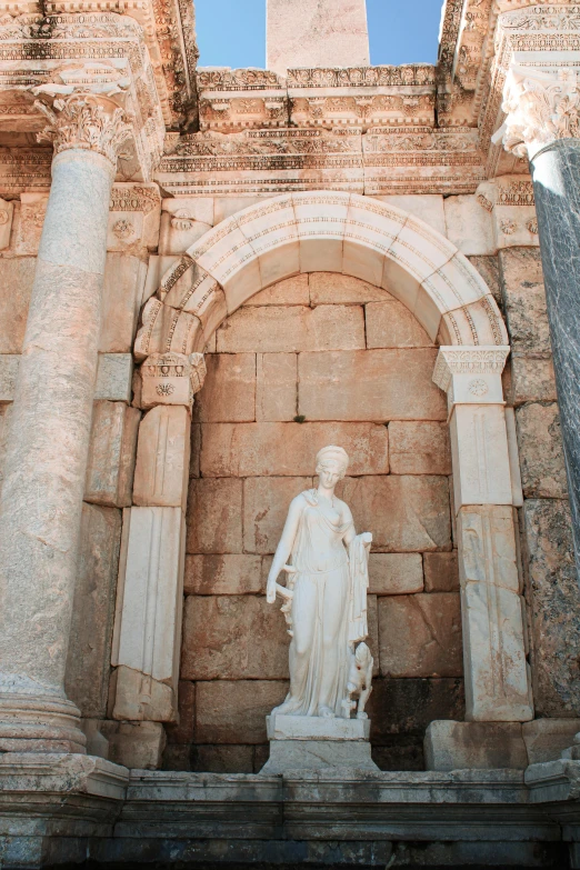 the statue of jesus is standing at the doorway to a stone building